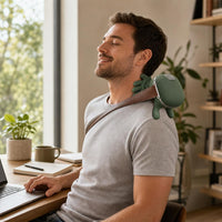 Man using the ComfyHug massager while working at his desk